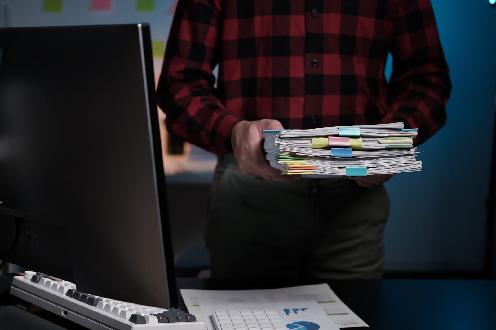 a man is holding a stack of papers in front of a c 2025 01 10 12 59 26 utc scaled